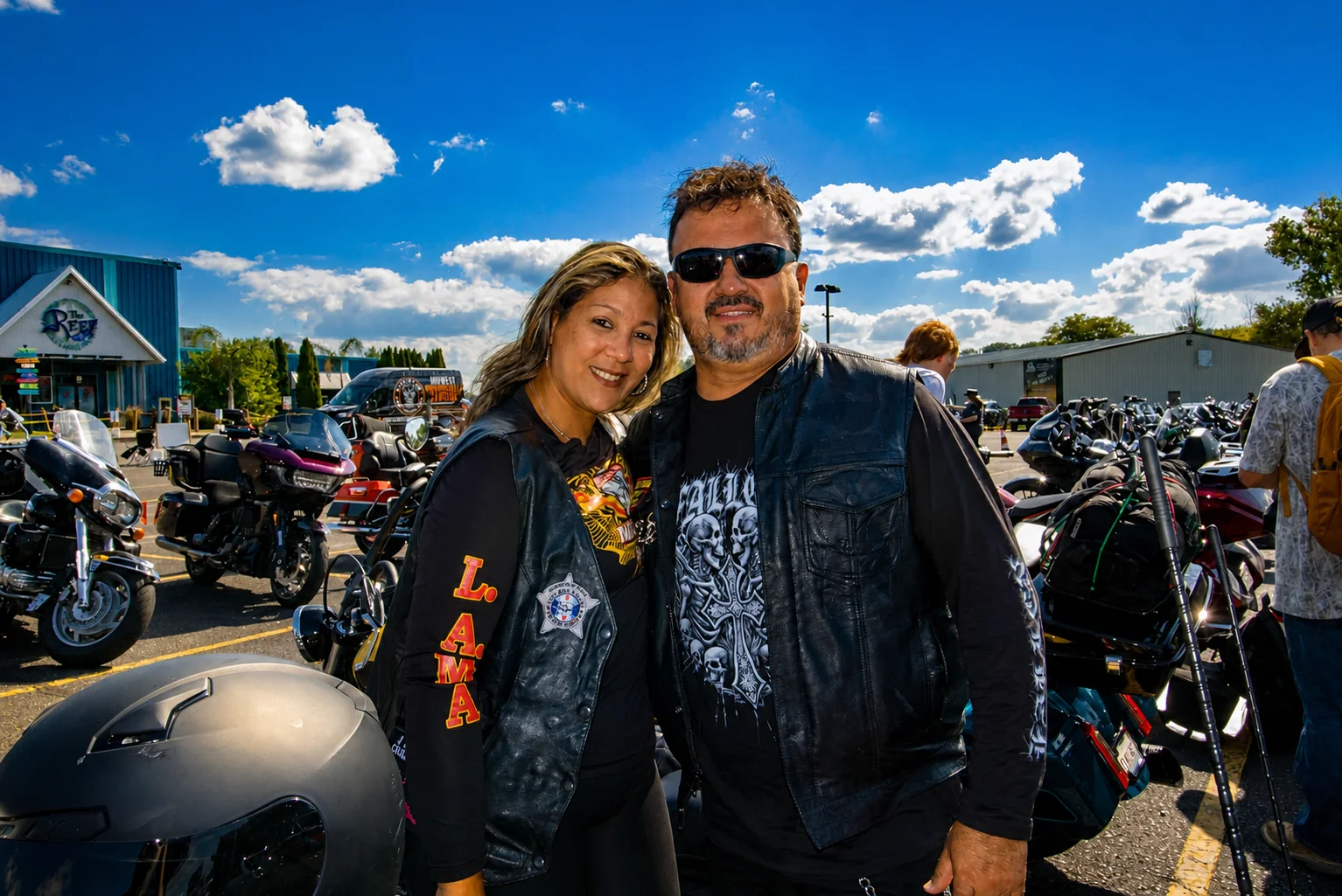 Two riders posing together among motorcycles