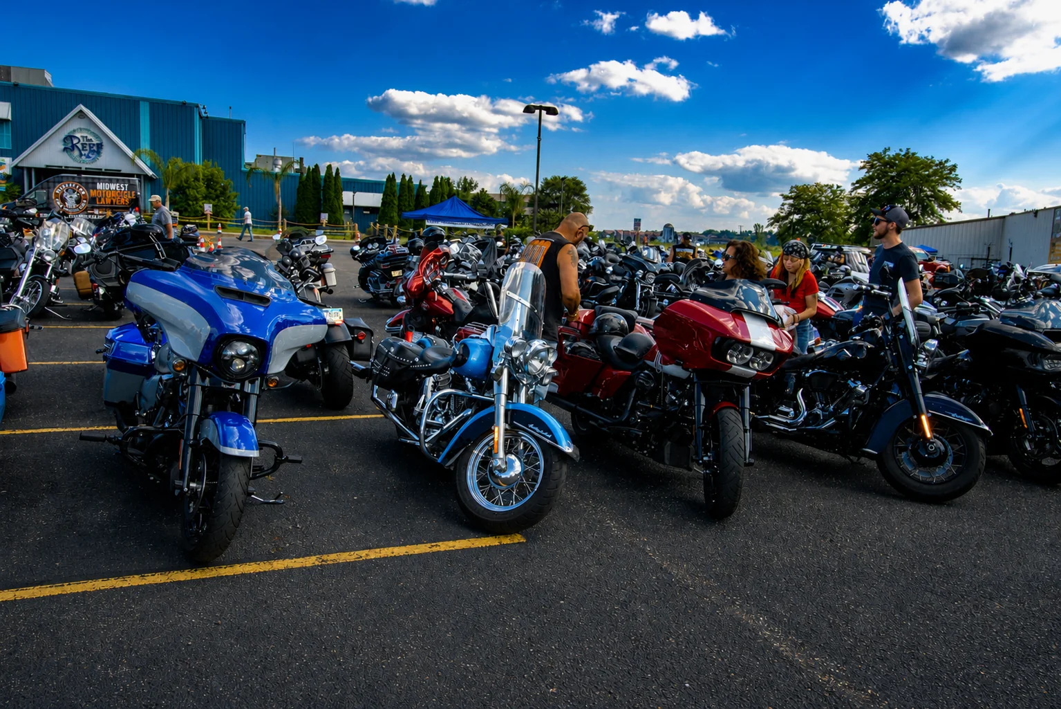 Colorful motorcycles lined up beneath a blue Wisconsin sky